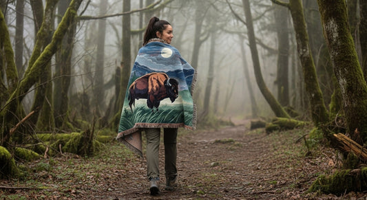 Person walking through a misty forest with a blanket featuring a bison design.