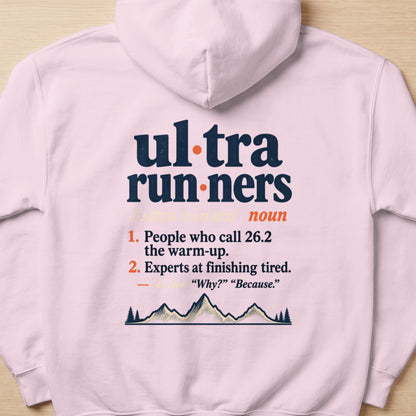 Pink hoodie with text defining "ultrarunners" and a mountain graphic.
