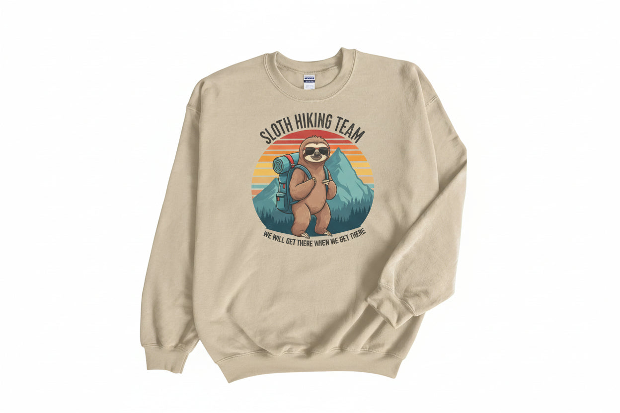 A long sleeve shirt with a graphic of a sloth hiking team, featuring a sloth with a backpack and mountains in the background.