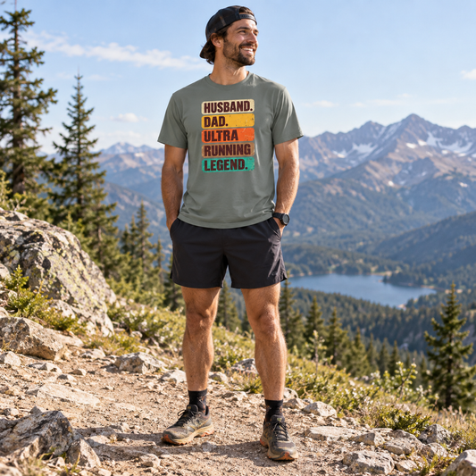 Man wearing a shirt that says "Husband. Dad. Ultra Running Legend." outdoors.