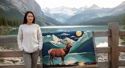 Woman standing next to a painting of a deer with a mountain landscape in the background