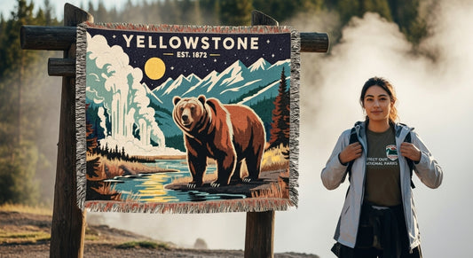 Woman standing next to a 'Yellowstone' sign with a bear illustration in a natural setting.