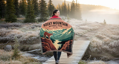 Person wrapped in a Rocky Mountain National Park blanket in a scenic outdoor setting.