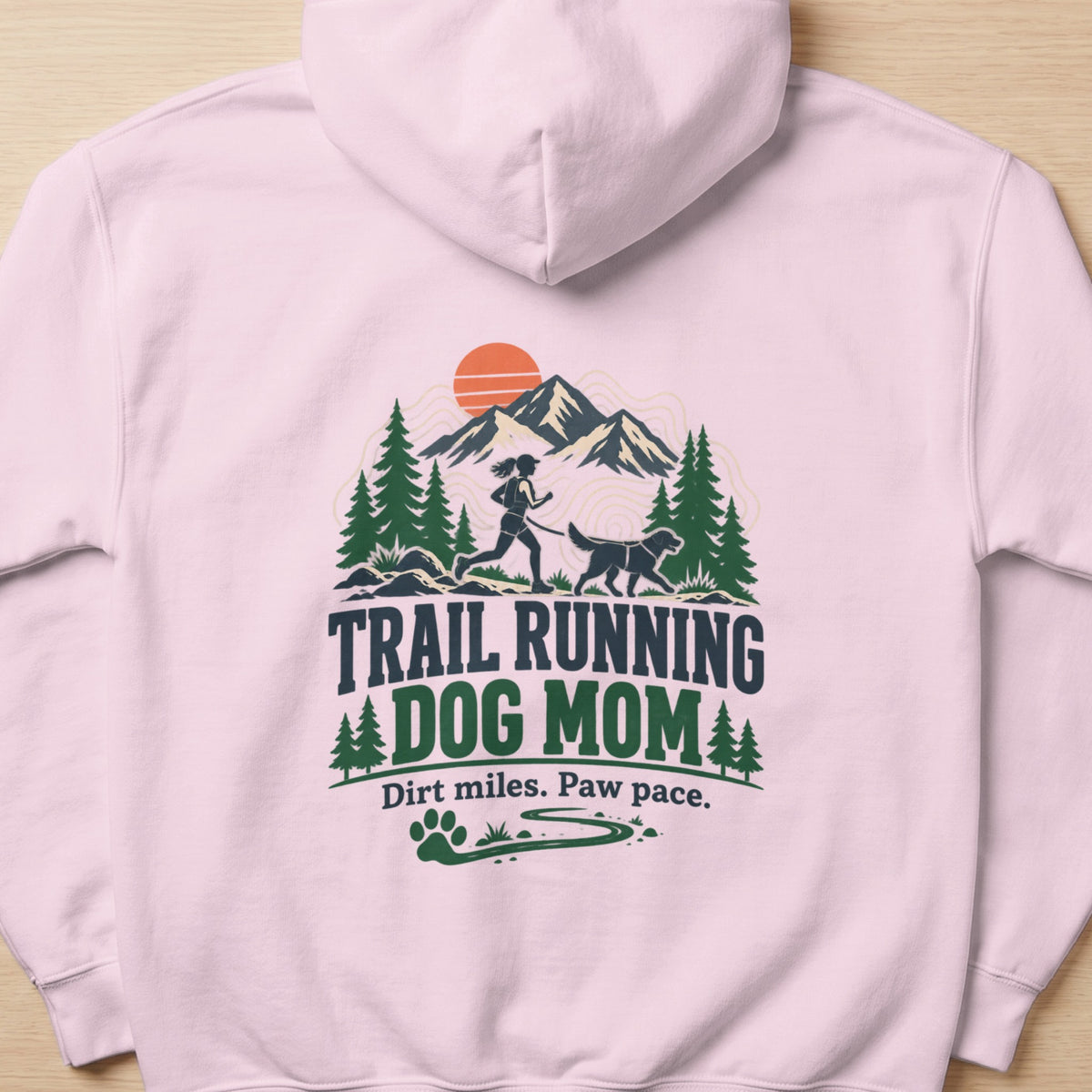 Trail running dog mom graphic with mountains, trees, sun, and dog paw print.