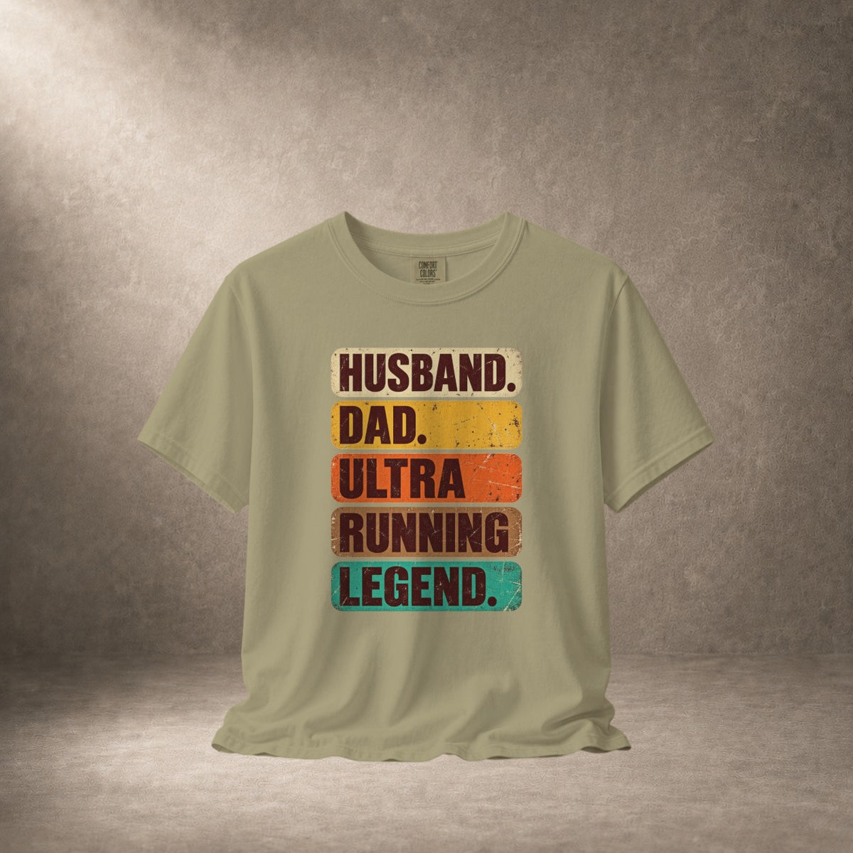 Light tan t-shirt with "Husband. Dad. Ultra Running Legend." text.