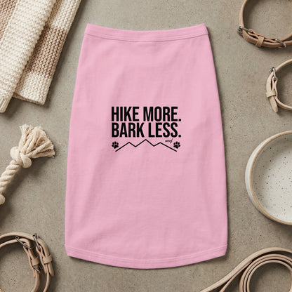 Pink dog shirt with "HIKE MORE. BARK LESS." text, paw prints, and mountains.