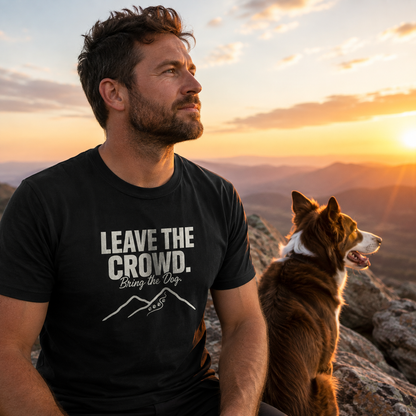 Man and dog on mountain at sunset wearing black t-shirt with "Leave the Crowd. Bring the Dog." text.
